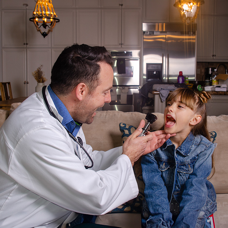 Dr. Velasco examining a child at home